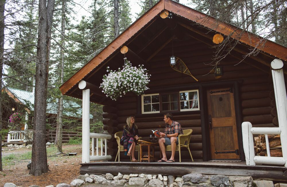 A couple enjoying a stay at a quaint mountain cabin in Banff National Park.